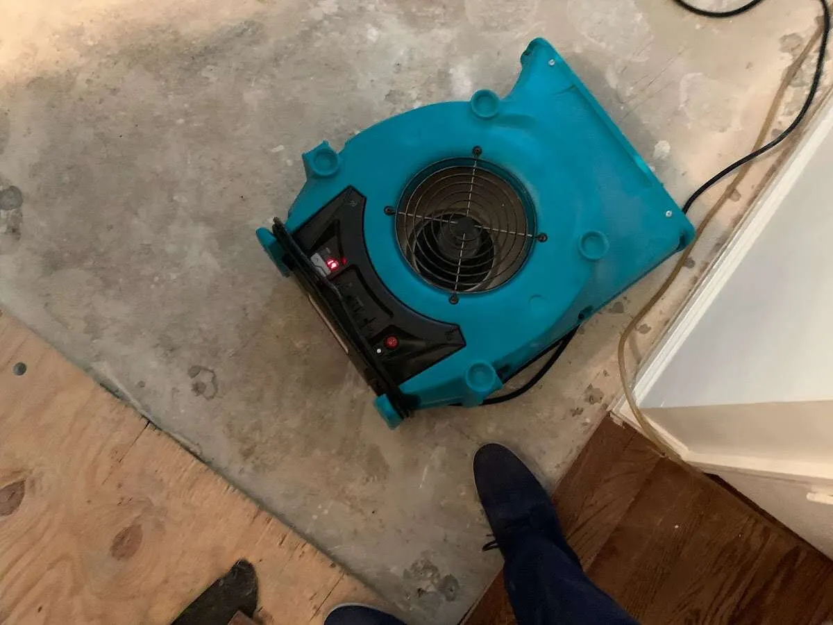 Air mover drying subfloor during Leak Detection & Repair in Crystal Lake
